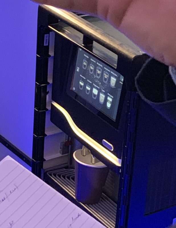 a machine with a screen and a cup on it