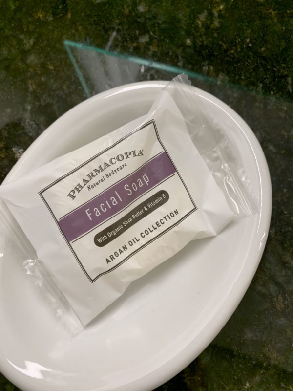 a white package of facial soap on a white plate