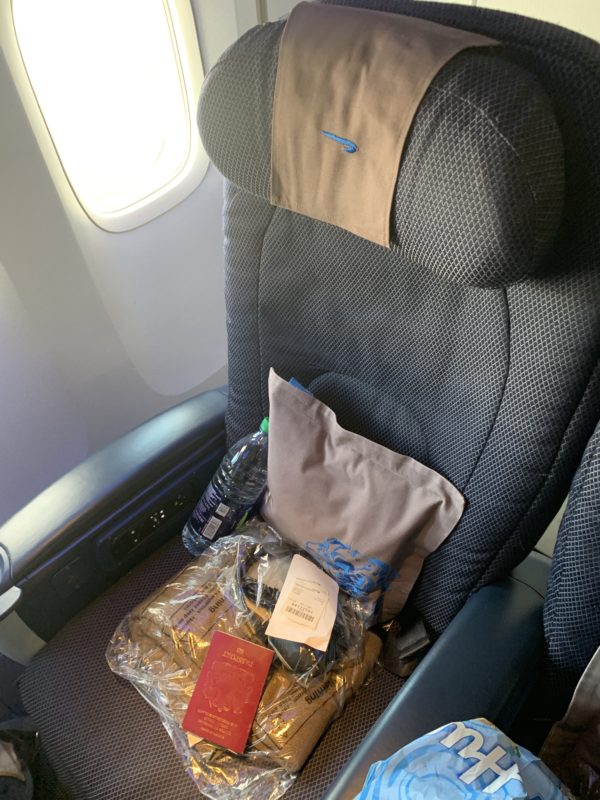 a seat with a bag of food and a bottle of water inside
