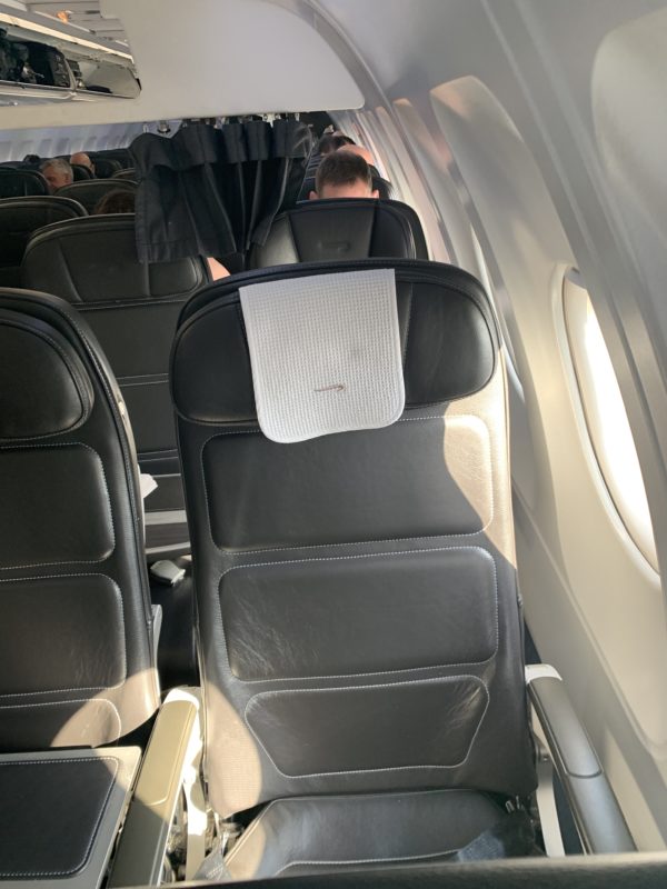 the inside of an airplane with black seats
