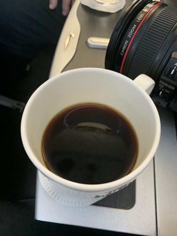 a cup of coffee next to a camera