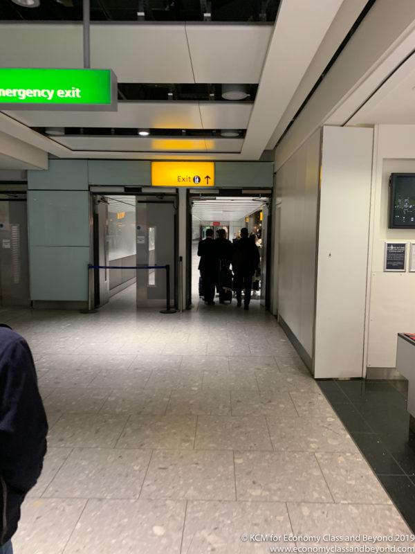 people walking through an emergency exit