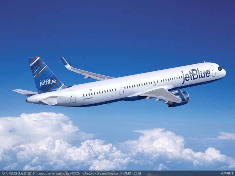 a jetblue airplane flying in the sky