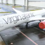 a large white airplane on a wet runway