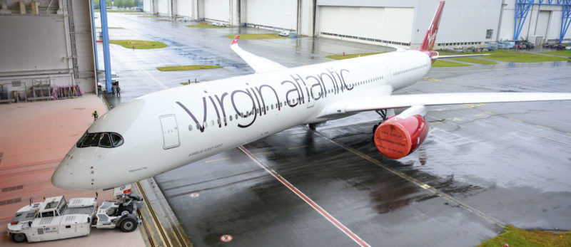 a large white airplane on a wet runway
