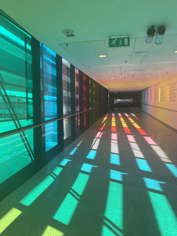 a long hallway with colorful windows