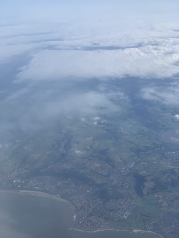 aerial view of clouds and land from an airplane