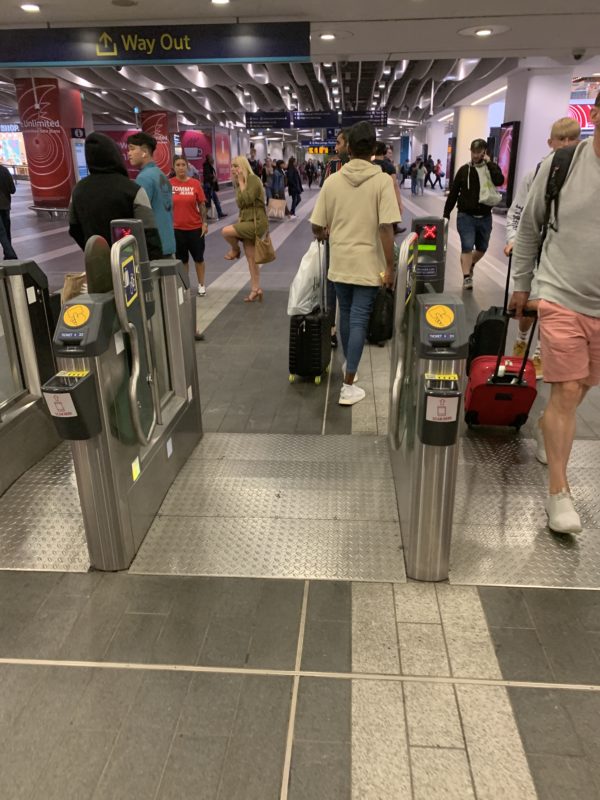people walking through a terminal