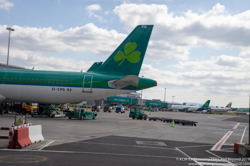 a green airplane with a clover on the tail