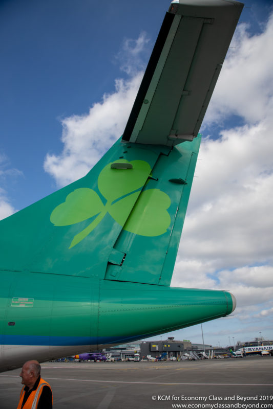 the tail of an airplane with a shamrock on it