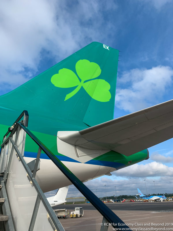 a tail of an airplane with a clover on it
