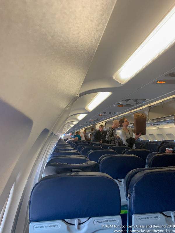 a group of people standing in an airplane