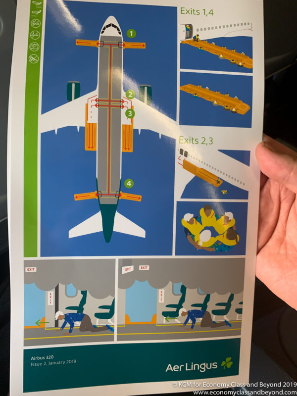 a hand holding a paper with a diagram of an airplane