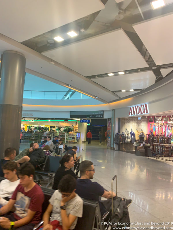 people sitting in a large airport