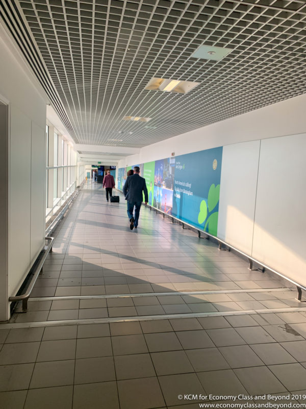 people walking in a hallway