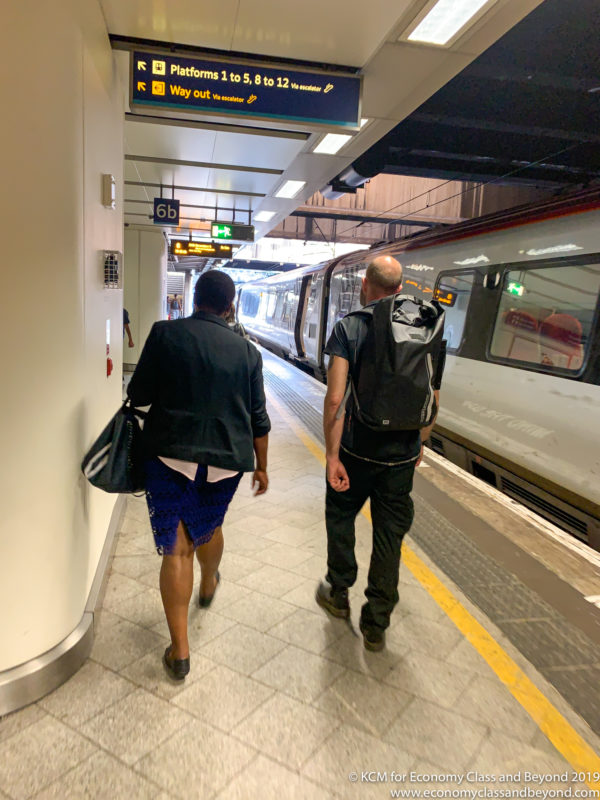 a man and woman walking in a train station