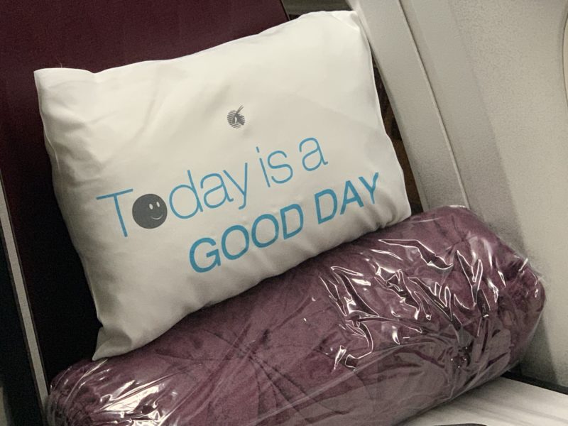 a white pillow with blue text on it