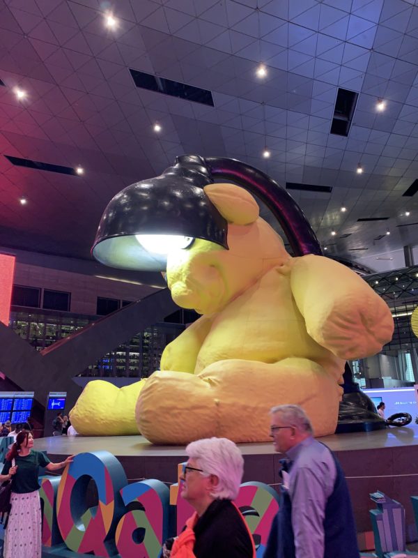 a large yellow stuffed animal with a lamp on its head