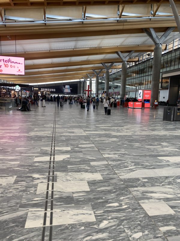 a large airport with people walking in the middle