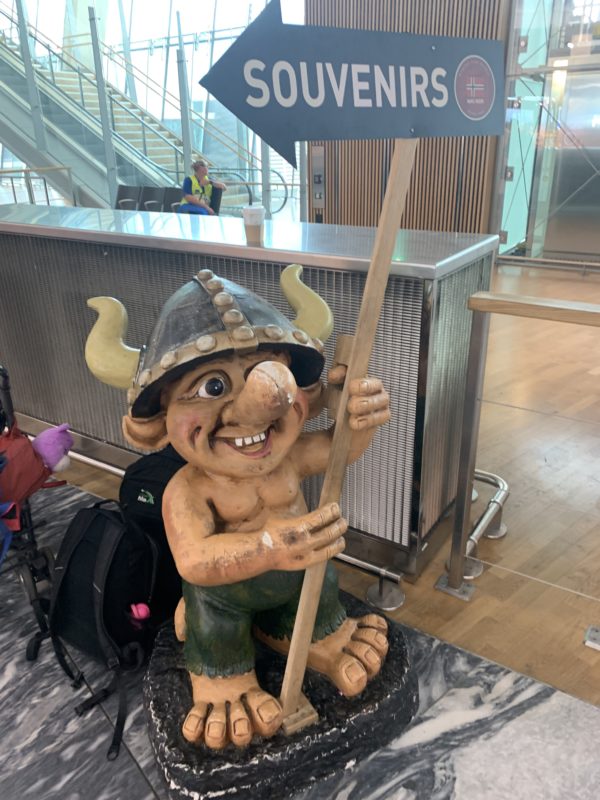 a statue of a troll holding a sign