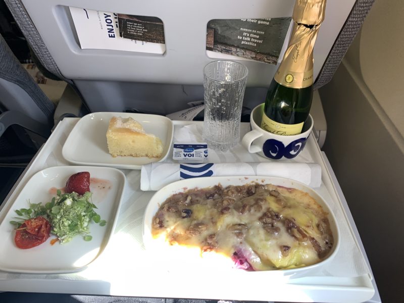 a tray of food and a bottle of champagne