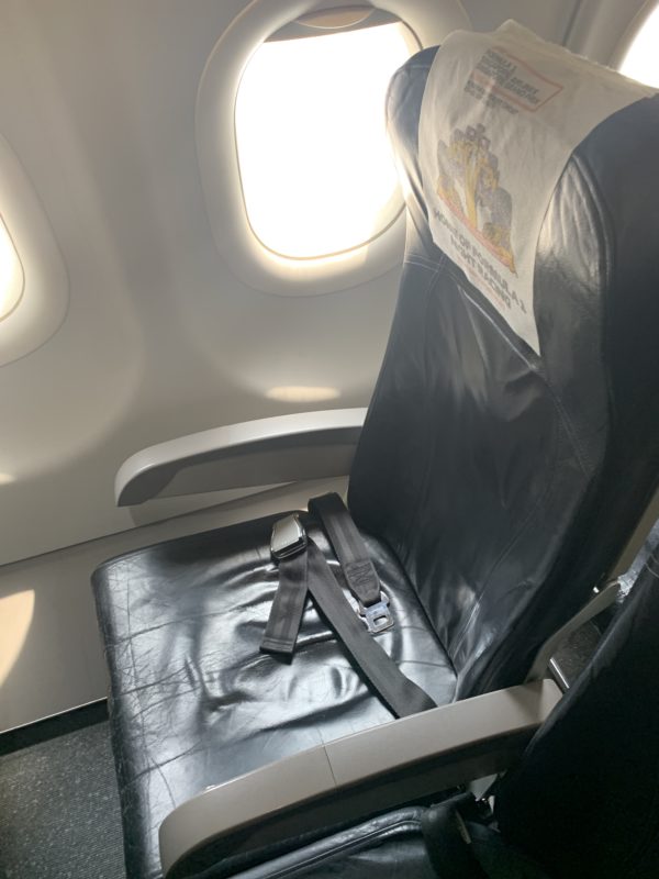 a seat belt on a seat in an airplane