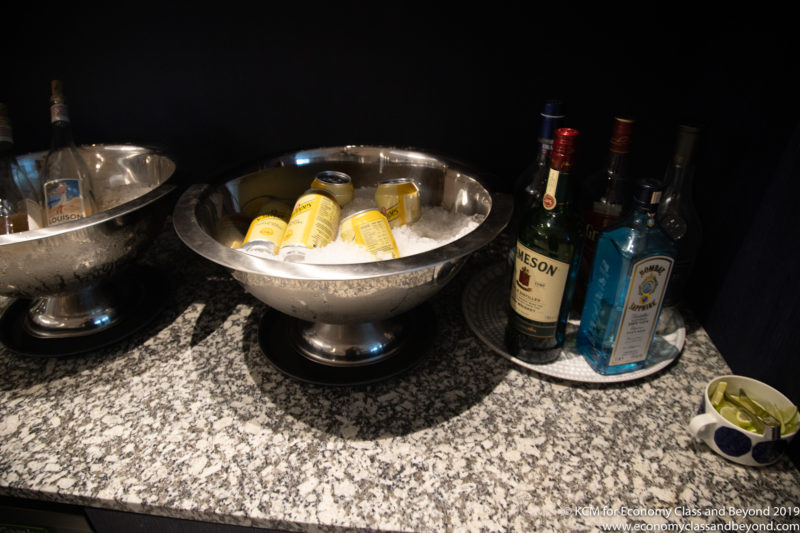 a bowl of ice and bottles of alcohol