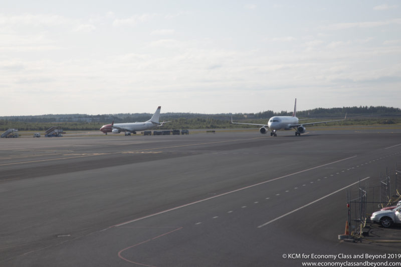 a couple of airplanes on a runway