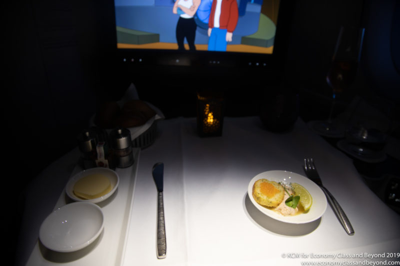 a plate of food on a table with a television