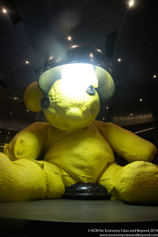 a yellow teddy bear with a light on its head