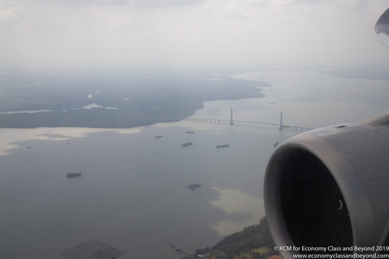 an airplane wing with a bridge and water