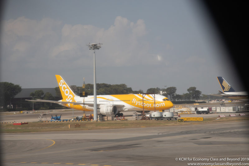 a large yellow and white airplane on a runway