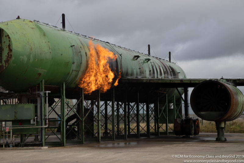 a large green tank with fire coming out of it