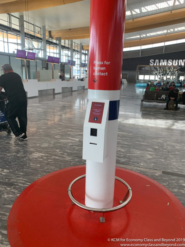 a red and white pillar with a white box on it