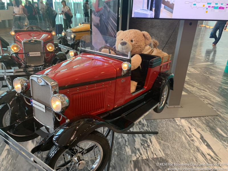 a teddy bear in a red car