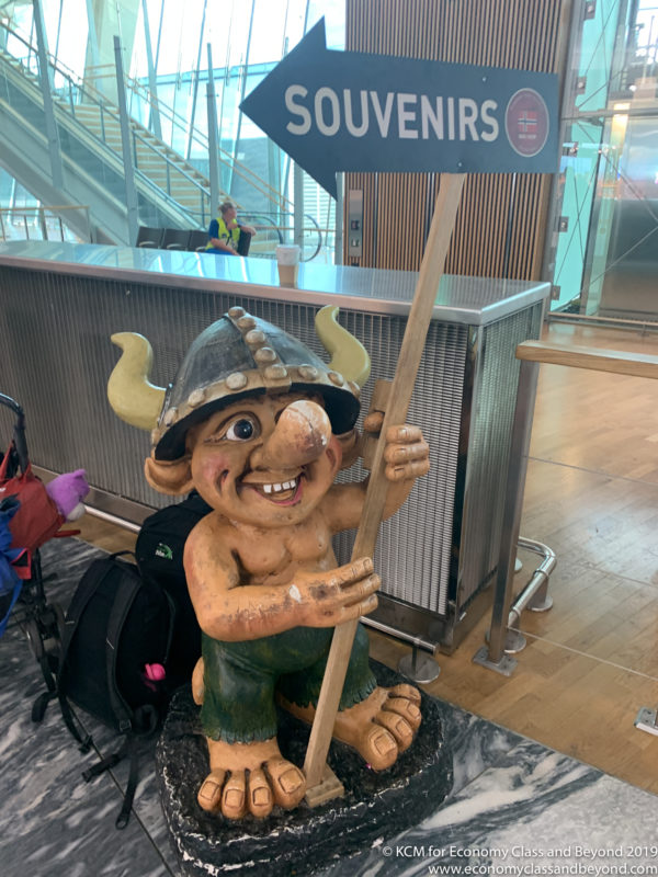 a statue of a troll holding a sign