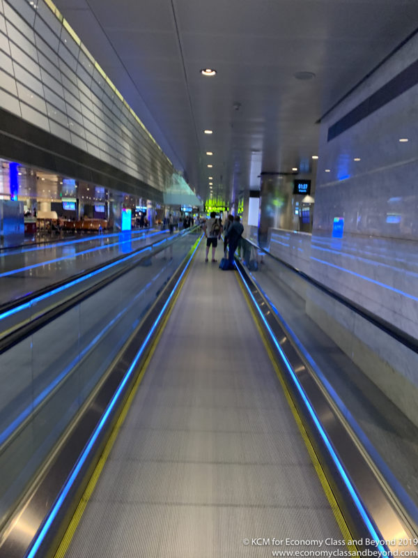 a group of people walking on an escalator