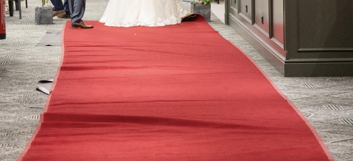 a woman in a white dress on a red carpet