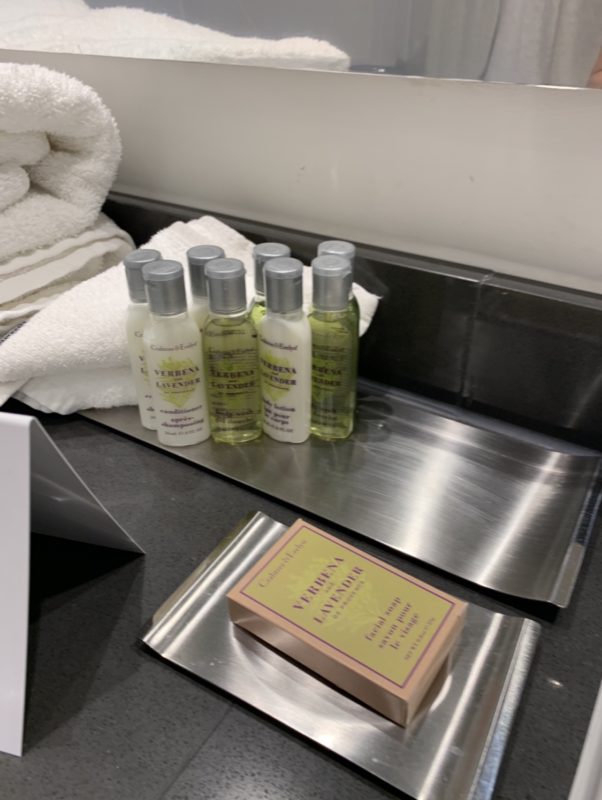 a group of small bottles of shampoo on a metal tray