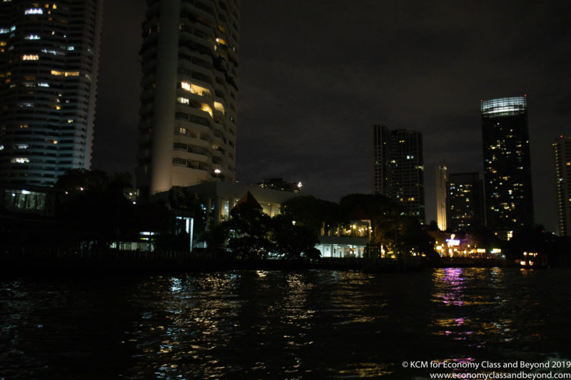 a body of water with buildings at night