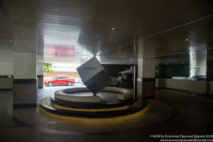 a cube on a circular platform in a parking garage