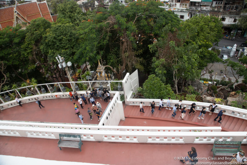 a group of people walking on a white staircase