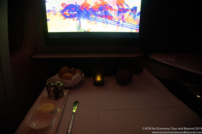 a table with a television and a plate of food