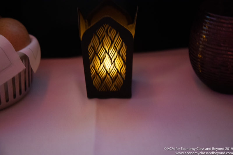a candle holder with a lit candle