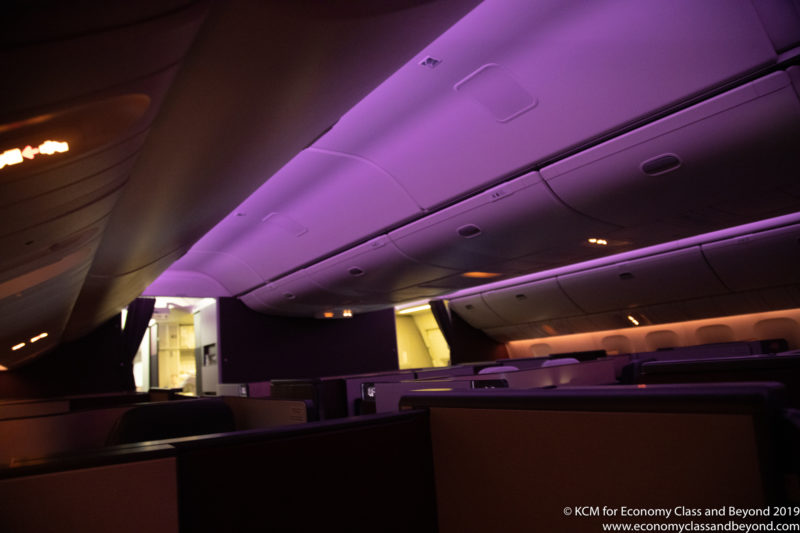 an inside of an airplane with purple lights