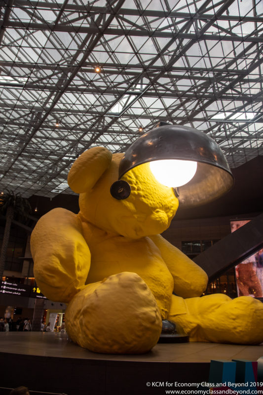 a large yellow teddy bear with a light on it