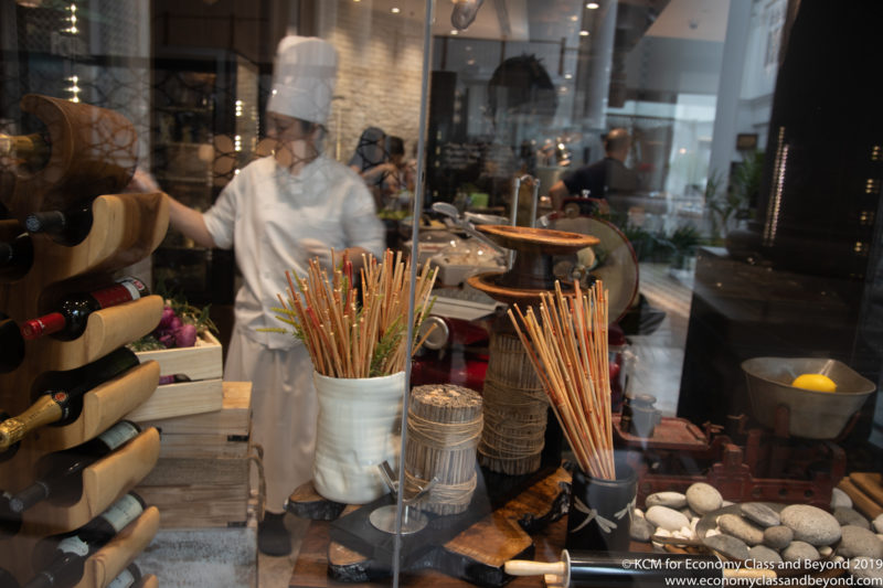 a chef standing in front of a window