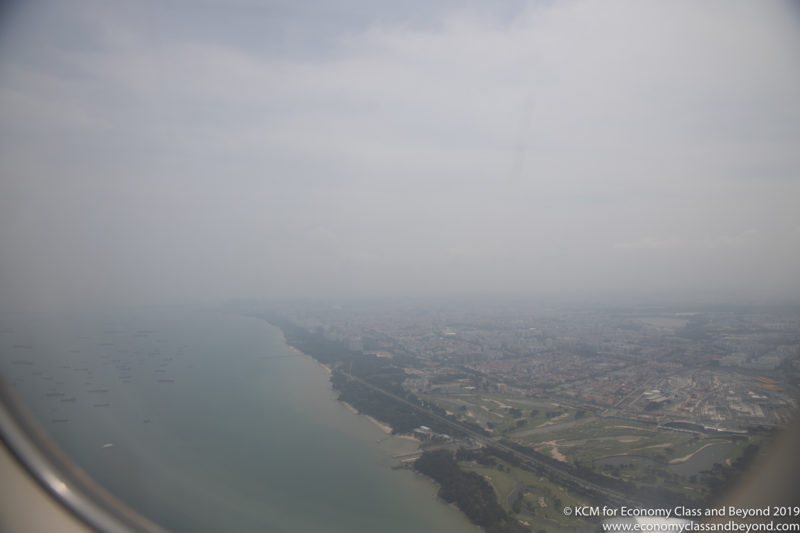 a view of a city and a body of water from a plane