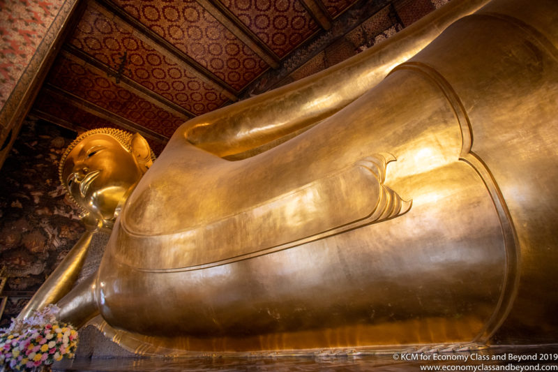 a large gold statue of a sleeping buddha