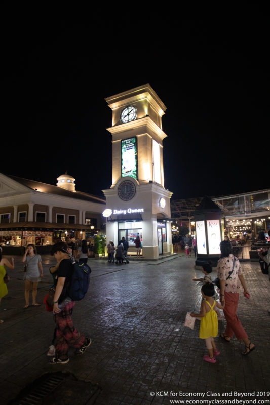 a clock tower with people walking around
